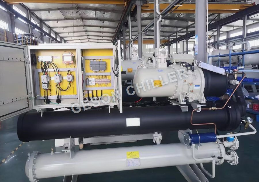 Factory photograph of a GESON water-cooled screw chiller control panel inspection